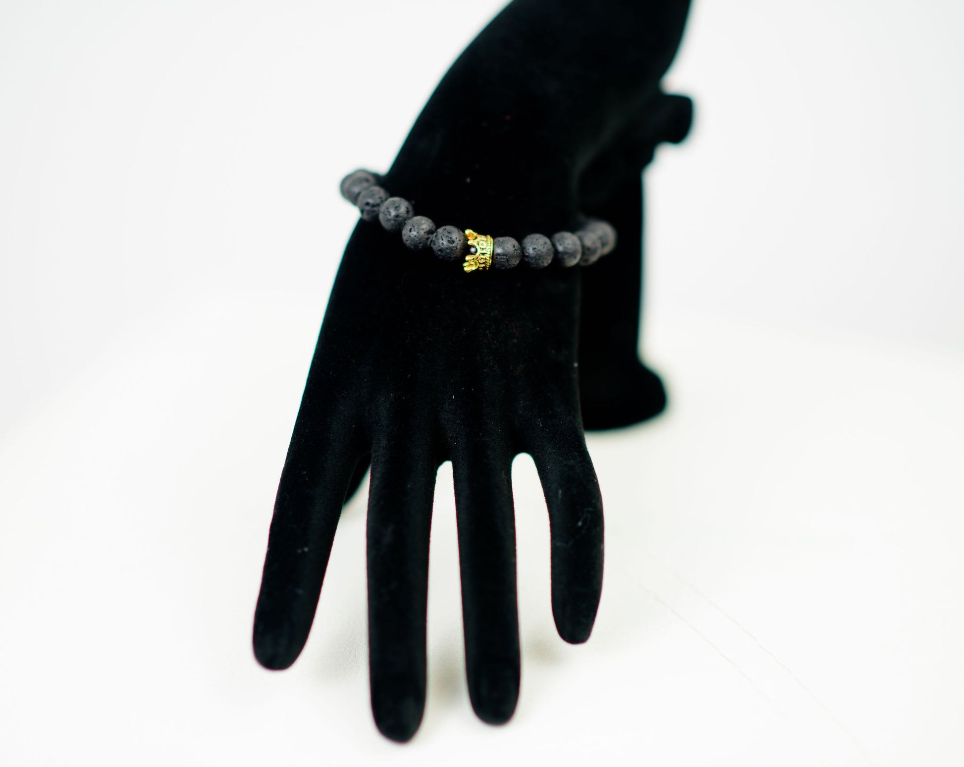 Nobility bracelet with lava stone with gold colored crown